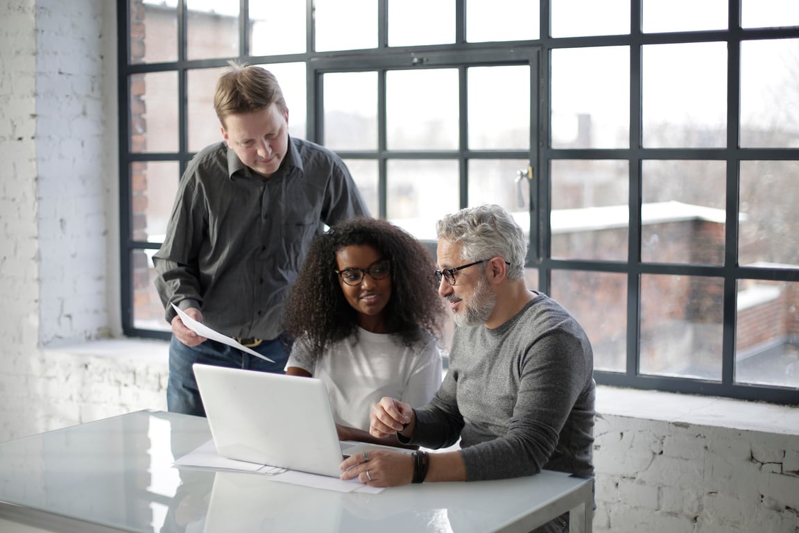 Happy diverse coworkers discussing business plan